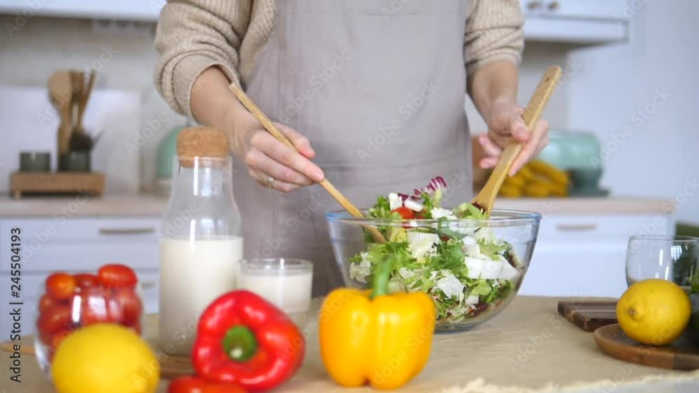 Close-Up Woman Stirring Salad On Kitchen. Healthy Vegan Food. Close-Up Woman Stirring Salad On Kitchen. Healthy Vegan Food.