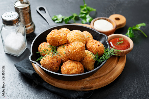 Canvastavla Potato croquettes - mashed potatoes balls breaded and deep fried, served with different sauce
