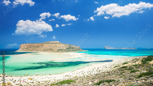 Balos lagoon on Crete island, Greece. Tourists relax and bath in crystal clear water of Balos beach. © Lucian Bolca