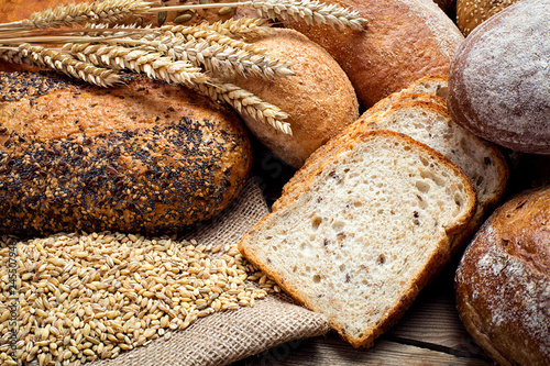 heap of fresh baked bread on wooden background