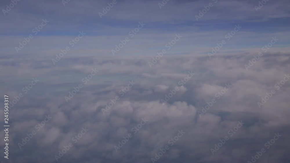 Aerial drifting across cloudscape in the sky with gentle blue background Aerial drifting across cloudscape in the sky with gentle blue background