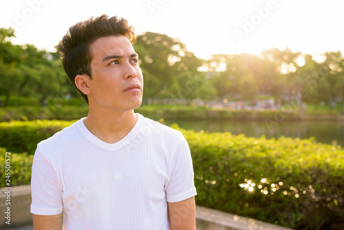 Young Asian man relaxing at the park