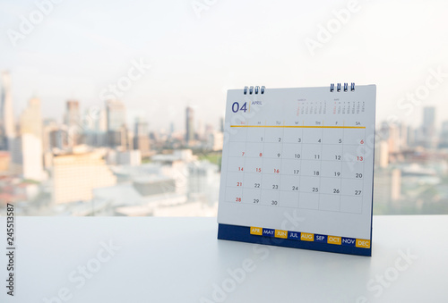 Calendar of April on the white table with city view background