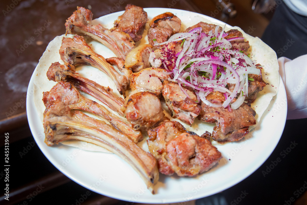 Mutton kebab on plate, close up view . Kebab with onion . Sheep meat Kebab. Mutton kebab on plate, close up view . Kebab with onion . Sheep meat Kebab.