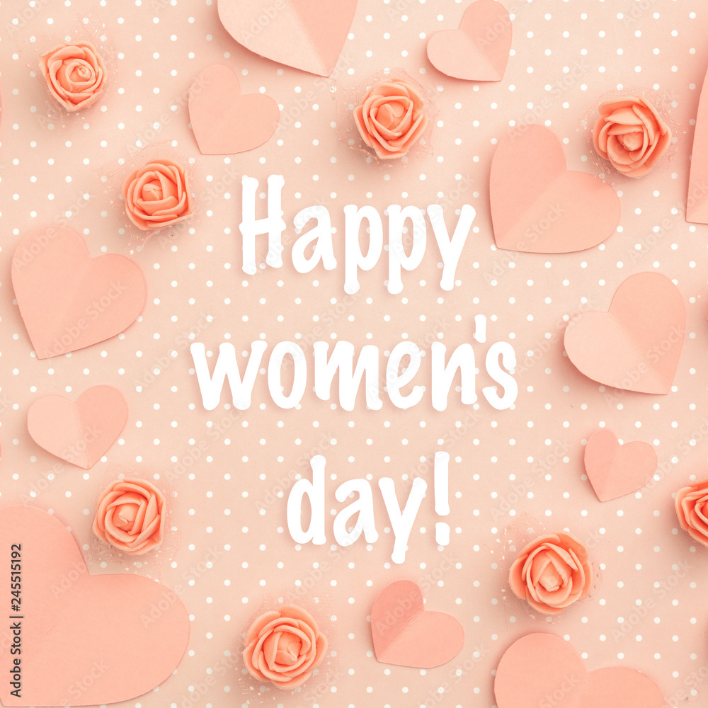 Happy Womens Day greeting card decorated paper hearts and flowers coral floral rose flat lay on living coral color background. Top view Happy Womens Day greeting card decorated paper hearts and flowers coral floral rose flat lay on living coral color background. Top view