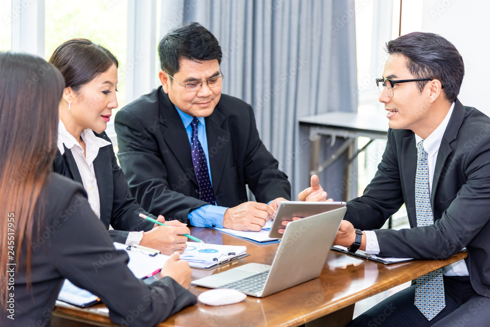 Team of professionals business partners discussing documents and ideas at meeting room.Businessman explaining new business ideas or Entrepreneurs and business people conference in board room. Team of professionals business partners discussing documents and ideas at meeting room.Businessman explaining new business ideas or Entrepreneurs and business people conference in board room.