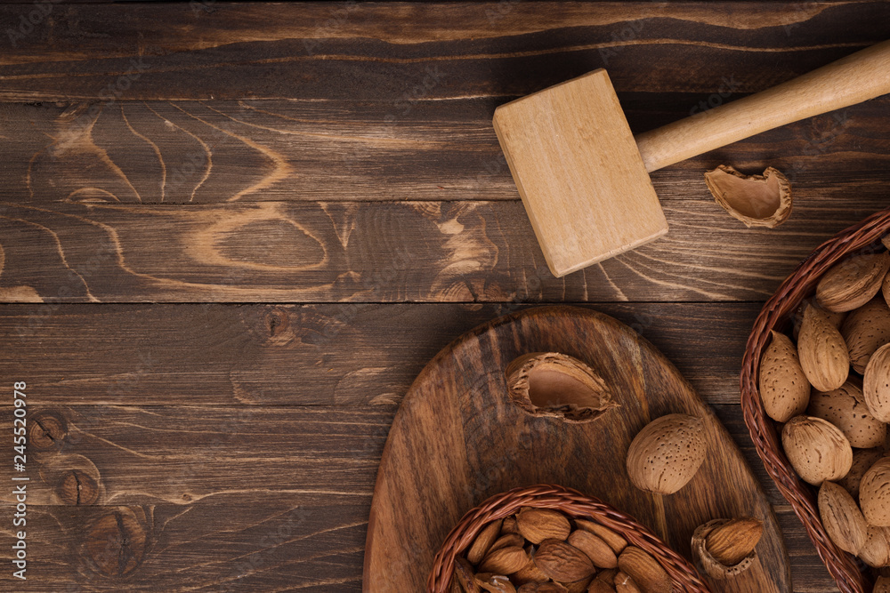 Flat lay of almonds in the wicker plates with other accessories on brown wooden background top view 7 Flat lay of almonds in the wicker plates with other accessories on brown wooden background top view 7