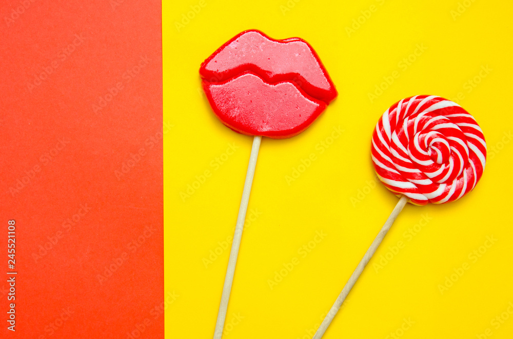 two lollipops on a red and yellow background two lollipops on a red and yellow background