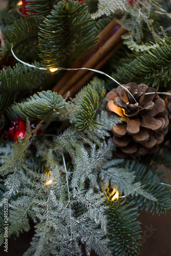 New Year's composition with fir-tree branches, cones and cinnamon