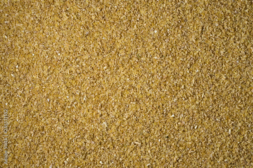 Crushed wheat groats background texture Crushed wheat groats background texture