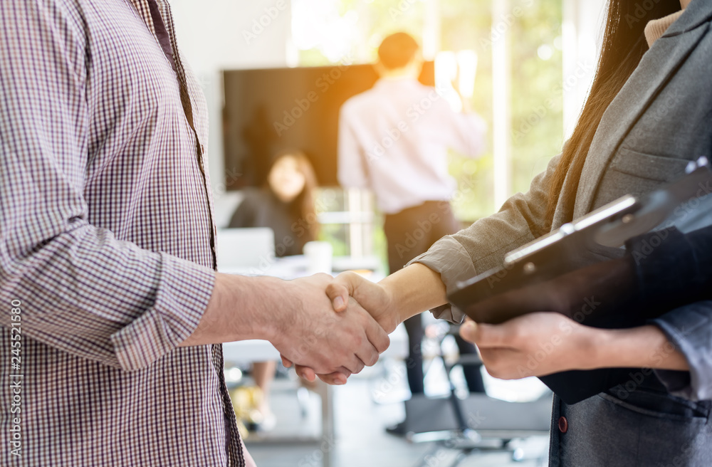 Obraz premium Two business people shaking hands conference training in meeting room ,finishing up a meeting.Business partners handshake while success job and project,greeting business deal,learning coaching concept