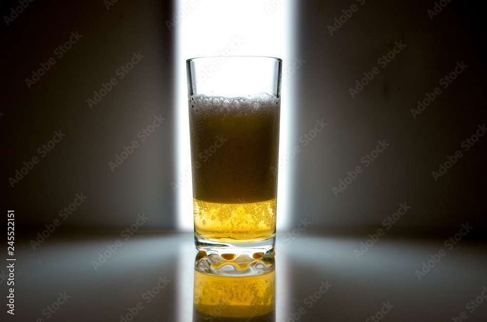 glass of beer on dark background,glass of cold beer on the table. object on a black background, а glass of beer, alcohol beverages, beer with foam black background glass of beer on dark background,glass of cold beer on the table. object on a black background, а glass of beer, alcohol beverages, beer with foam black background