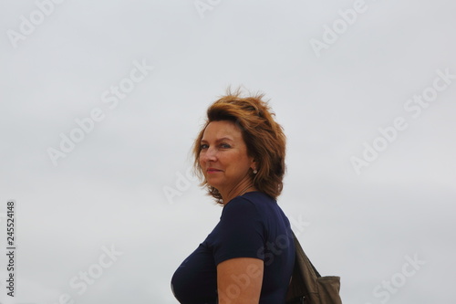 young woman looks, hair develops in the wind
