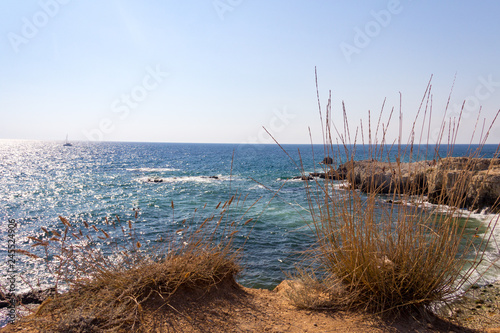 Landscape sea waves line impact rock on the beach. Stones at the beach with wave and nice blue sky. turquoise water