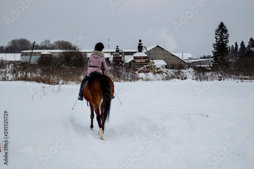girl riding a horse on a winter walk