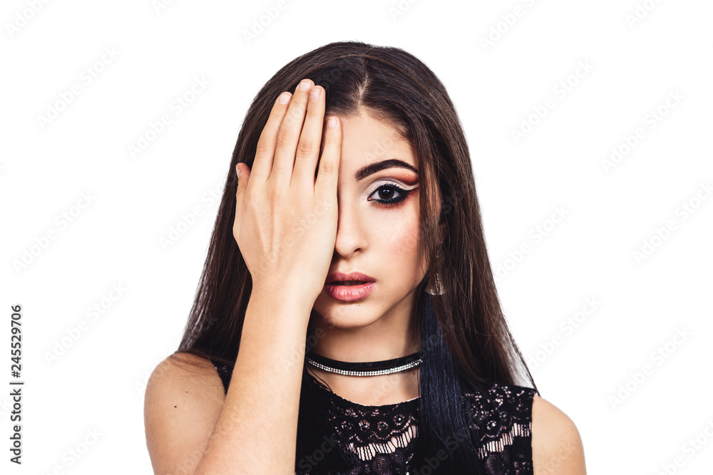 Young beautiful oriental girl closes the right eye with her hand. Young beautiful oriental girl closes the right eye with her hand.