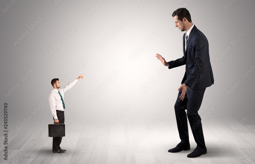 Small businessman in shirt pointing to an afraid businessman
Small businessman in shirt pointing to an afraid businessman