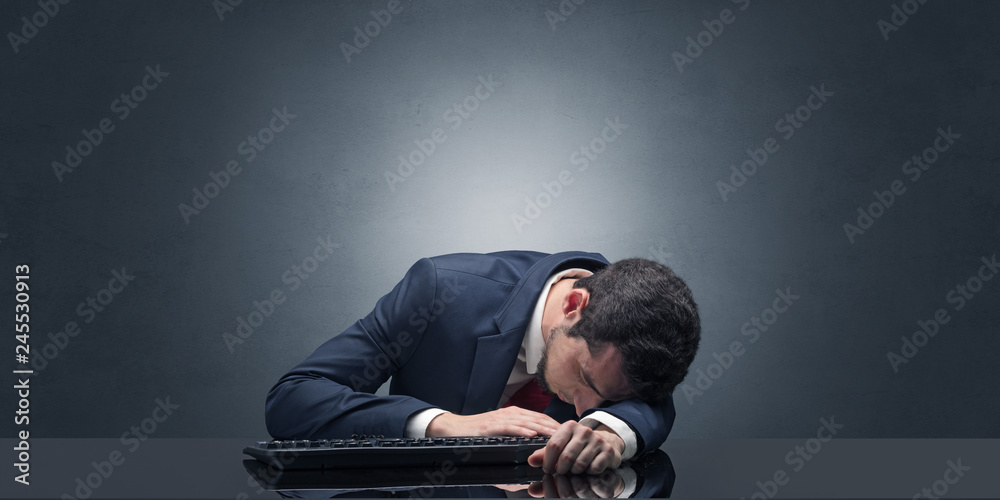 Young businessman fell asleep at his workplace with copy space Young businessman fell asleep at his workplace with copy space