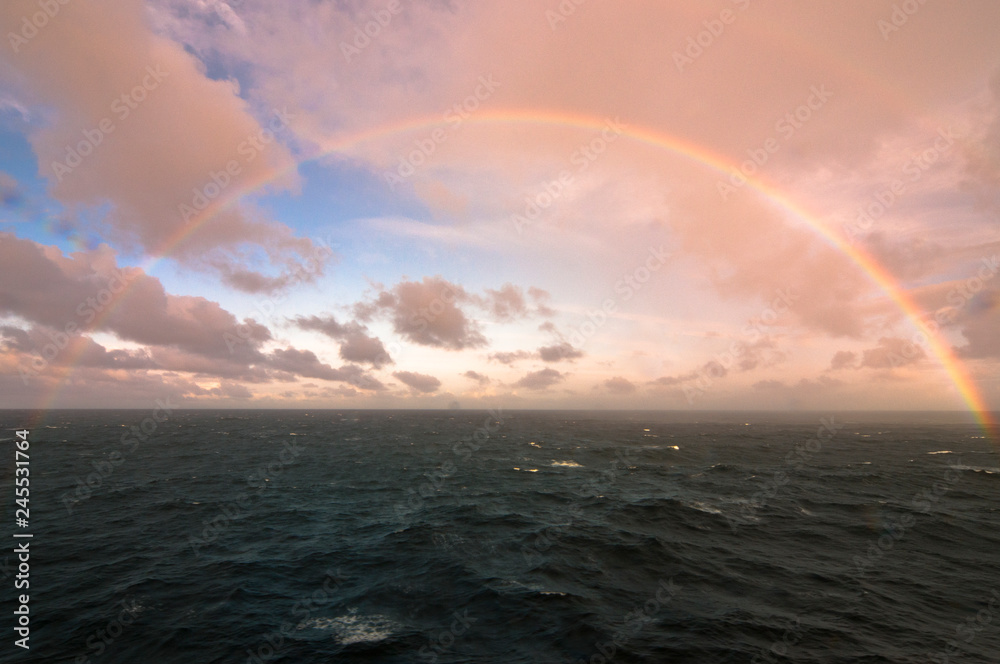 rainbow in the middle of the sea