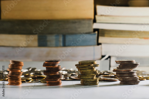 Stack of coins on books background.....