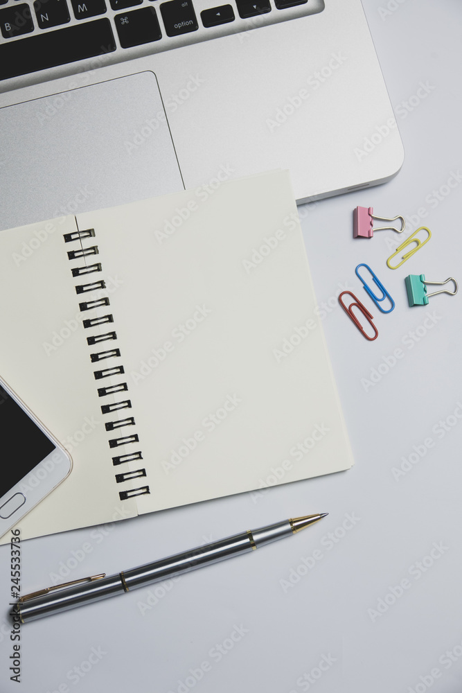 White office desk, computer keyboard, mobile phone and other office supplies on table. Top view with copy space, flat lay. White office desk, computer keyboard, mobile phone and other office supplies on table. Top view with copy space, flat lay.