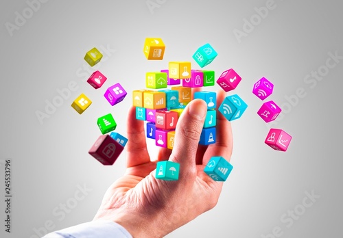 Media technology and internet networking web communication concept- Colorful icon cubes holding by hand.