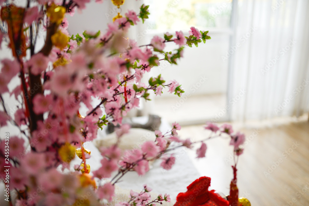 Cherry blossom, Sakura flowers, artificial flowers, fabric flowers in the modern room with windows full of light through white curtains