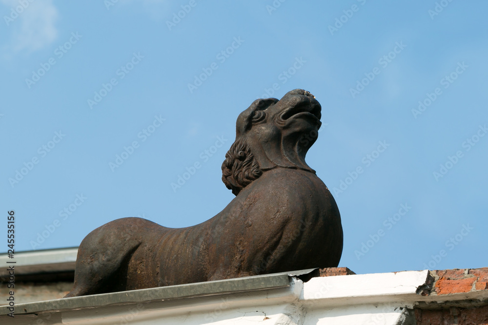 Cast iron sculpture of the beast in the city. Sculpture dog decoration building architecture design.