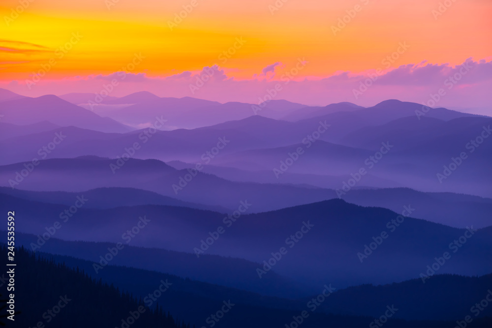 beautiful violet mountain chain silhouette at the sunset