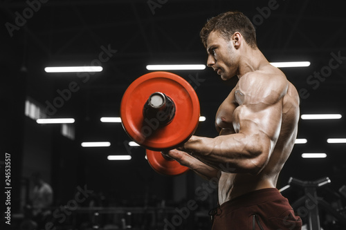 Handsome strong athletic men pumping up muscles workout barbell curl bodybuilding concept background