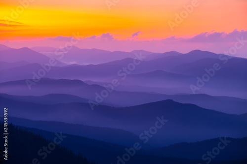 beautiful violet mountain chain silhouette at the sunset
