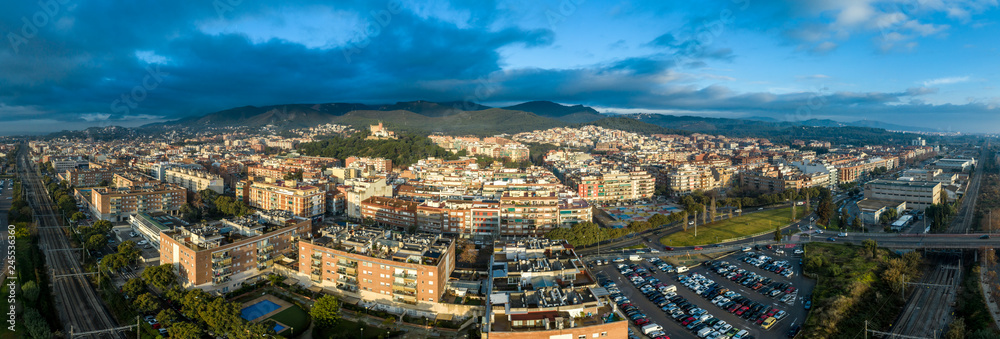 Aerial panorama view of Castelldefels, popular Costa Brava Spanish beach town with modern buildings and hilltop medieval castle near Barcelona