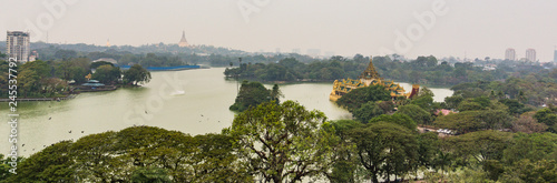 view of Kandawgyi Lake on a rainy evening with golden Shwedagon Pagoda in the distance  photo