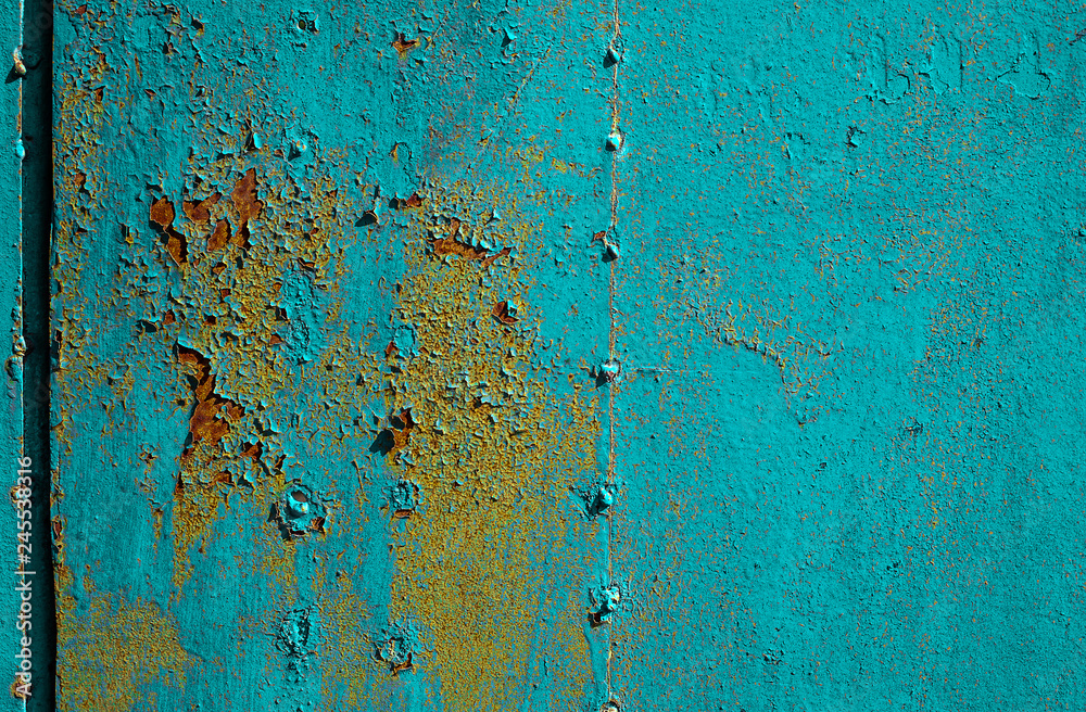 Texture of old rusty metal, painted blue which becames orange from rust. Horizontal texture of cracks and peels paint on rusty welded steel sheets