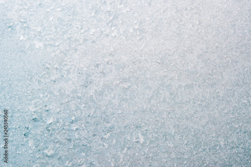 Frozen winter abstract background on the window glass with copy space