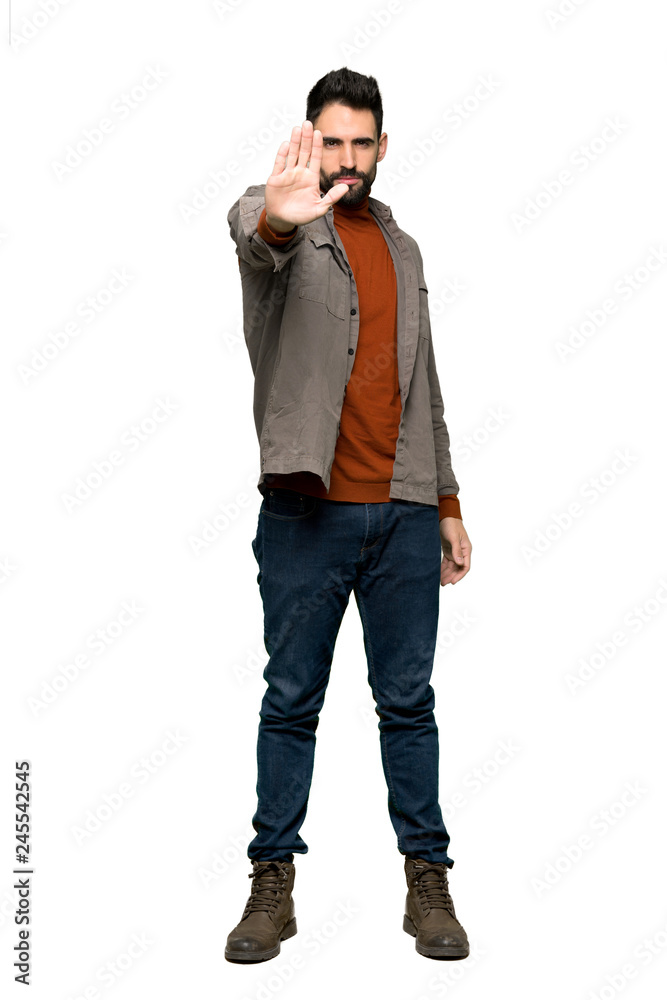 Full-length shot of Handsome man with beard making stop gesture denying a situation that thinks wrong on isolated white background Full-length shot of Handsome man with beard making stop gesture denying a situation that thinks wrong on isolated white background