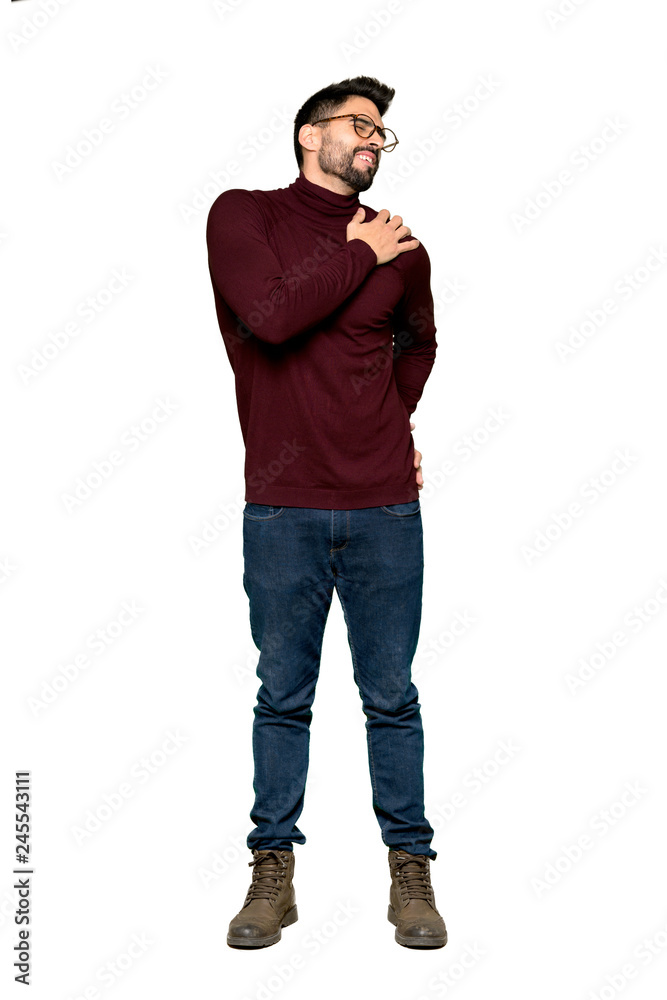 Full-length shot of Handsome man with glasses suffering from pain in shoulder for having made an effort on isolated white background Full-length shot of Handsome man with glasses suffering from pain in shoulder for having made an effort on isolated white background