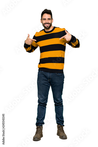 Fototapeta Naklejka Na Ścianę i Meble -  Full-length shot of Handsome man with striped sweater proud and self-satisfied in love yourself concept on isolated white background