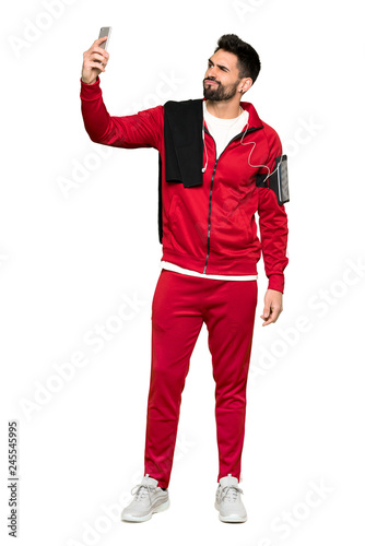 Full-length shot of Handsome sportman making a selfie on isolated white background