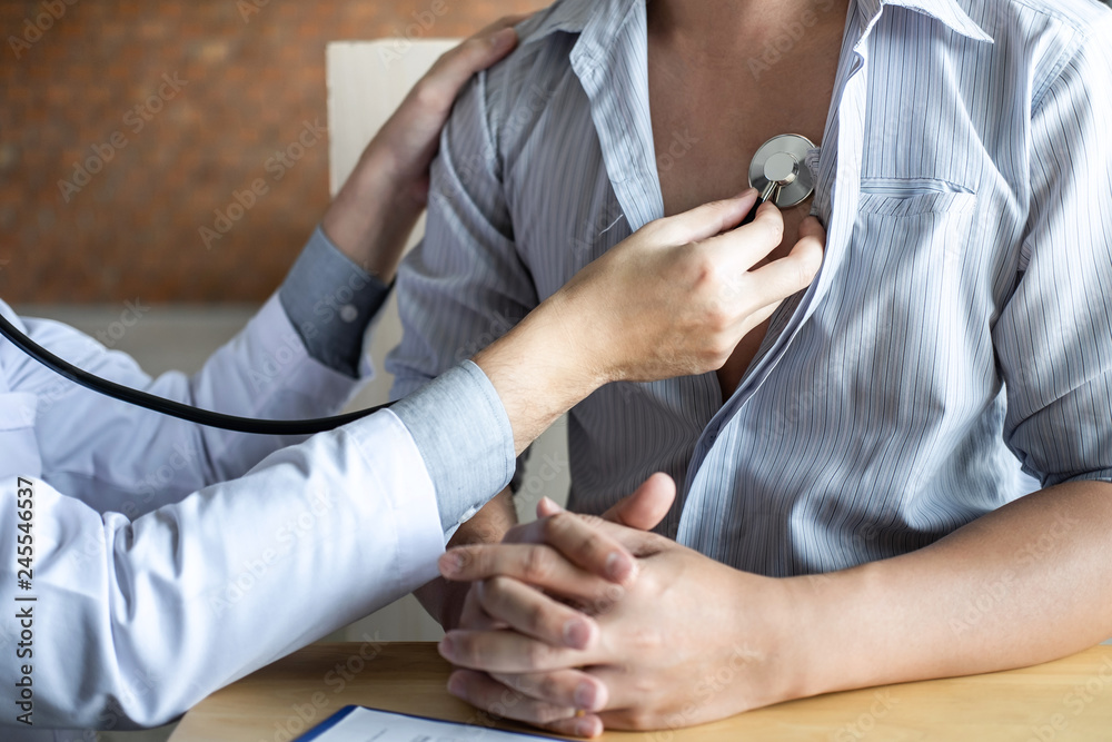 Doctor using a stethoscope checking patient with examining diagnosis Doctor using a stethoscope checking patient with examining diagnosis