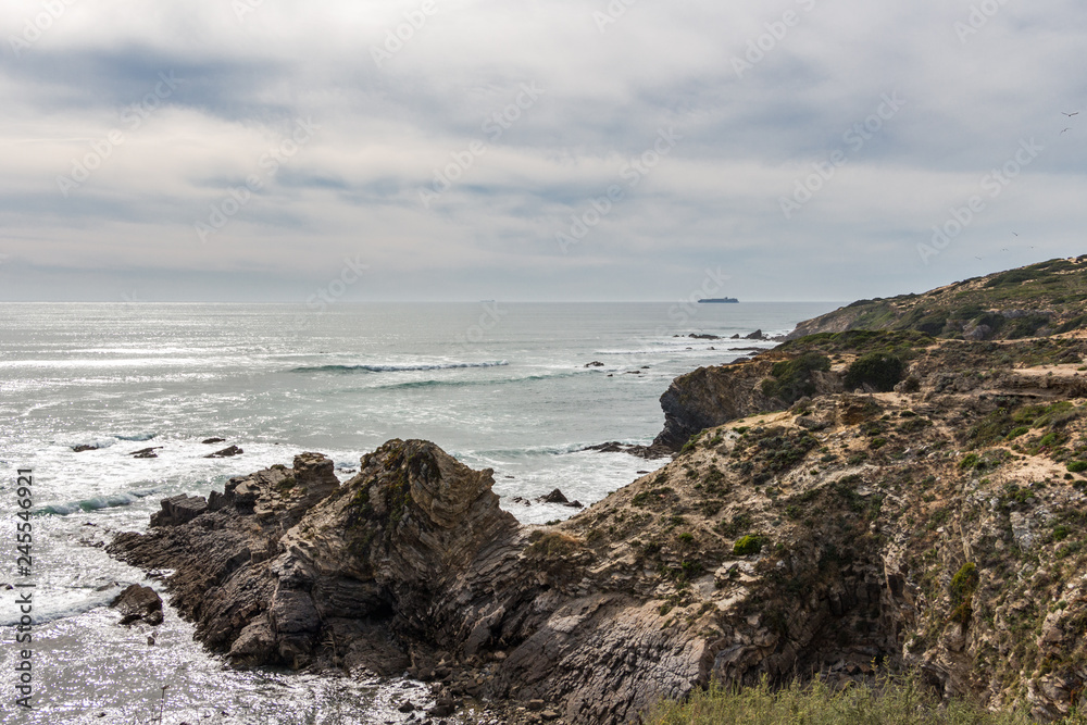 Beautiful view over cliffs and rocks in the ocean. Cloudy day. Nature scenery. Beautiful view over cliffs and rocks in the ocean. Cloudy day. Nature scenery.
