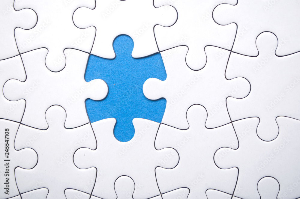 closeup of the last piece of jigsaw puzzle missing on blue background to complete the mission closeup of the last piece of jigsaw puzzle missing on blue background to complete the mission