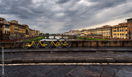 Landscape with yellow bikes. View of the river Arno. Florence. Italy.