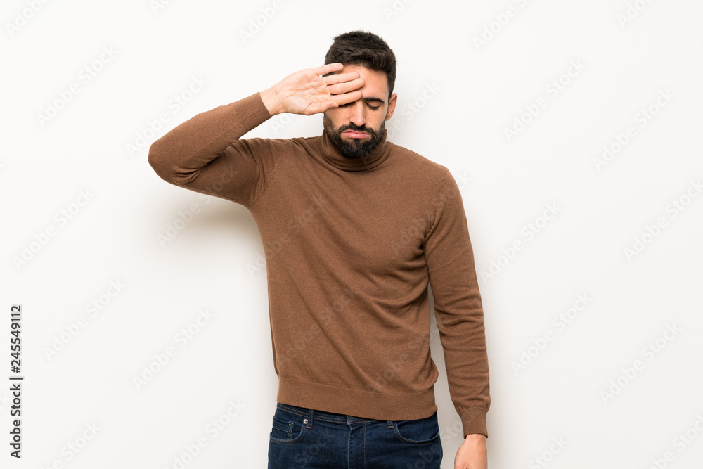 Handsome man over white wall with tired and sick expression Handsome man over white wall with tired and sick expression