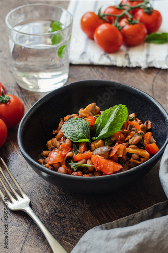Vegetable Stew with Beans, Mushrooms and Tomatoes on a wooden background