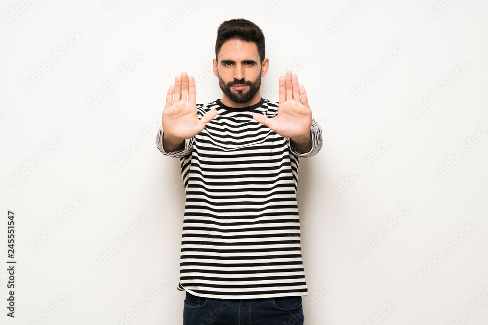 Naklejka premium handsome man with striped shirt making stop gesture for disappointed with an opinion