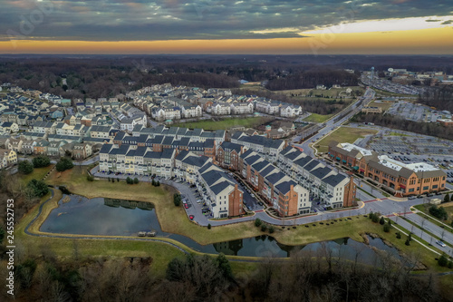 Fototapeta Naklejka Na Ścianę i Meble -  Aerial view of typical East Coast USA newly constructed suburban luxury townhouse community real estate in Maryland with brick facade the American Dream