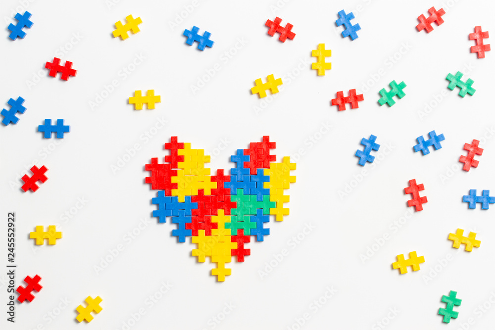 Top view on heart made of colorful plastic construction bricks on white background Top view on heart made of colorful plastic construction bricks on white background
