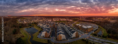 Aerial sunset panorama view of typical East Coast USA newly constructed suburban luxury townhouse community real estate in Maryland with brick facade the American Dream #245552977