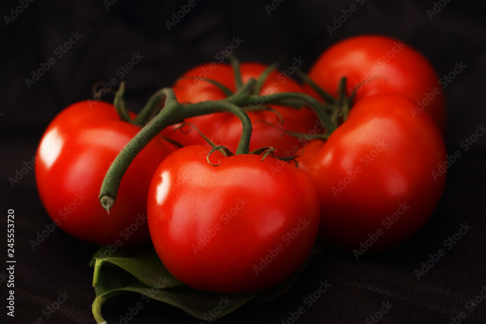 bunch of tomatoes on a leaf